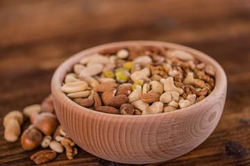 wooden bowl full of different muxture variety of nuts 
