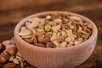 wooden bowl full of different muxture variety of nuts 
