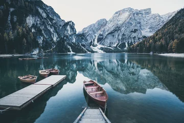 Wall murals Lake / Pond Wooden boat at the alpine mountain lake