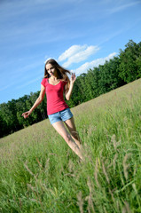 Woman with jeans shorts in the meadow