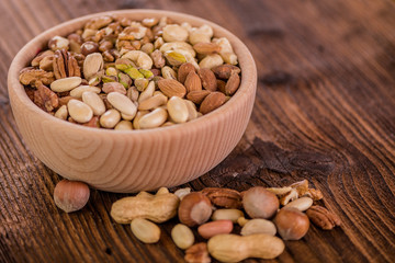 wooden bowl full of different muxture variety of nuts 