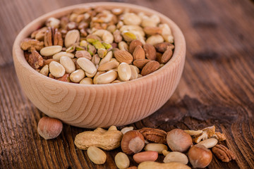 wooden bowl full of different muxture variety of nuts 