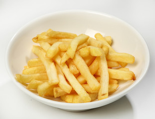 Garnish of french fries in a white plate on a white background