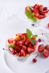 Healthy lifestyle. Two glasses of healthy mix fruit salad on white table background