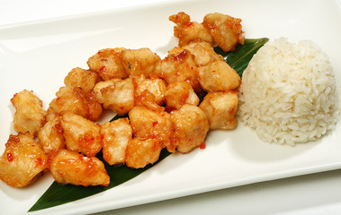 Chicken in a spicy-sweet sauce-fried chicken in tempura, with Sriracha sauce, with a side dish of rice