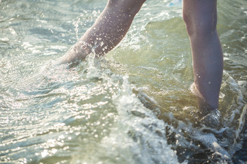 Closeup of a female's bare feet walking at a beach. Concept of the travel, vacation
