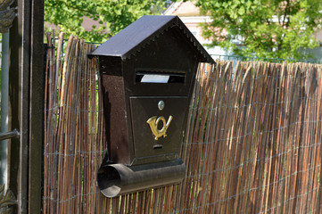 An old mailbox with a letter inside.