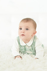 Fototapeta premium Cute little baby girl on white blanket