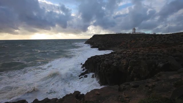 Lighthouse at rocky Atlantic ocean coastline. Carvoeiro Cape, Peniche, Portugal
