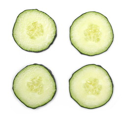 Cucumber slices isolated on white background, top view