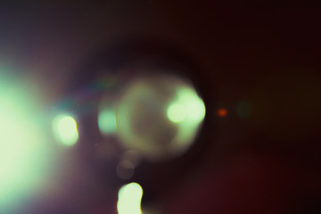 Ray of lamp spot light lens over black background, square stage abstract illumination