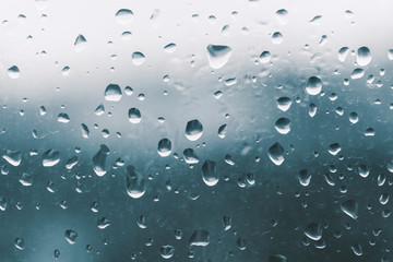 Raindrops on the window glass, blue background