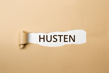 HUSTEN Schriftzug - aufgerissenes Papier