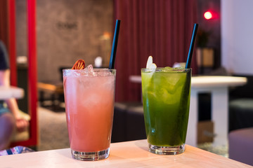 Alcohol bar, cocktail glasses with straws on bar counter