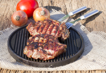 Steak on the grill. Fried meat. Fille on the frying pan