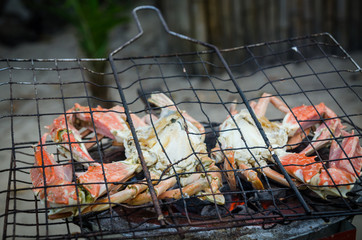 Giant crab beeing grilled on simple coal fire barbecue at Tokeh Beach, Sierra Leone, Africa