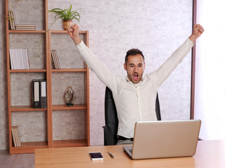 Young man at home celebrating a goal from his team.