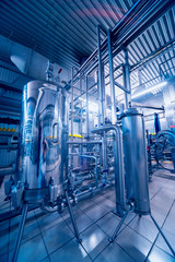 Fototapeta premium Modern interior of a brewery. Barrels and pipes. Factory interior.