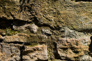 Old stone brick walls of natural stone with dust cobweb and mud textured background