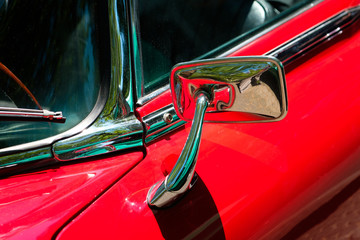 rear mirror, car mirror closeup on red oldtimer car -