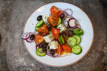 Greek salad with fresh vegetables, feta cheese and black olives
