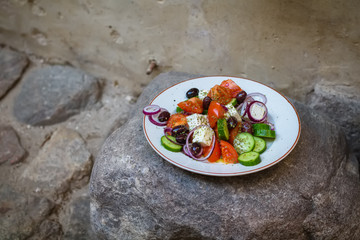 Greek salad with fresh vegetables, feta cheese and black olives