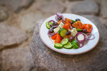Greek salad with fresh vegetables, feta cheese and black olives