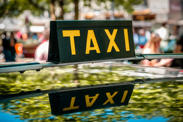 vintage taxi sign on car roof - cab driver -