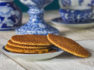 Typical symbol of Netherlands, white and blue porcelain and homemade stroopwafel.
