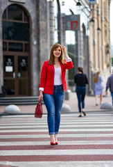 girl in the jacket goes on the pedestrian crossing