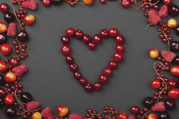 frame of ripe red currant berries, cherries and raspberries