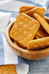 Crunchy crackers in a wooden bowl.