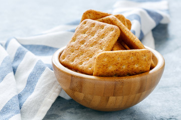 Crackers with bran in a wooden bowl.