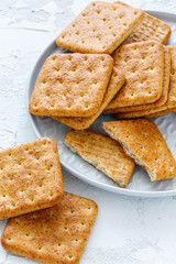 Whole grain crackers on a white plate.