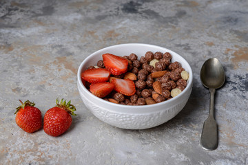 Healthy breakfast  with muesli,  berries and nuts ongrey background. Healthy food concept.