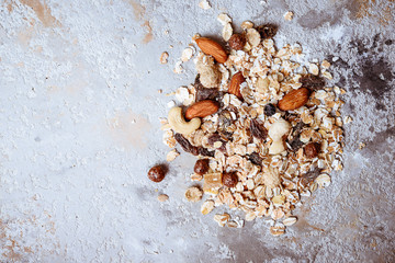 Healthy food concept with muesli and nuts on grey background. Top view