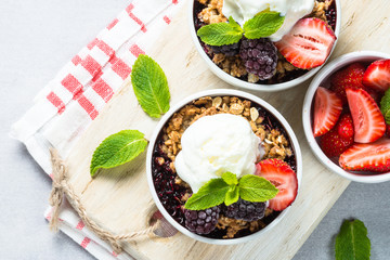 Crumble pie with berry mix, granola and ice cream.