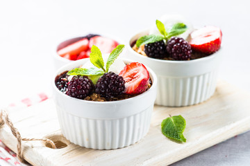 Crumble pie with berry mix, granola and ice cream.
