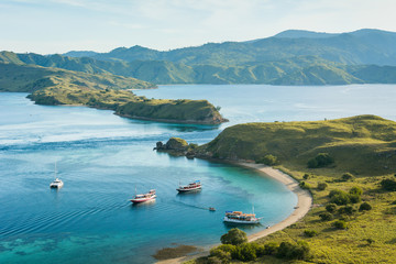 Tourist boats from the top view of 'Gili Lawa' in an evening, Komodo Island (Komodo National Park), Labuan Bajo, Flores, Indonesia - obrazy, fototapety, plakaty