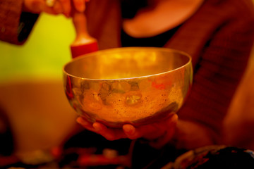 spiritual girl immersed in meditative sounds of tibetian bowl.