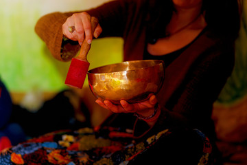 spiritual girl immersed in meditative sounds of tibetian bowl.