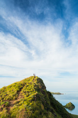 A couple on the top of 'Gili Lawa', Komodo Island (Komodo National Park), Labuan Bajo, Flores, Indonesia © Thrithot