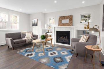 Beautiful living room interior with hardwood floors and fireplace in new luxury home