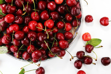 Cherry. Red fresh Cherries in bowl and a bunch of cherries on the table