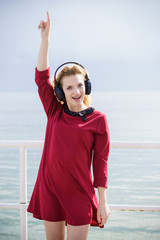 Happy woman wearing headphones outdoor