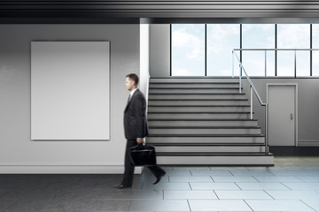 Businessman walking in modern school corridor