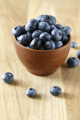 ripe organic bog whortleberry in a wooden plate