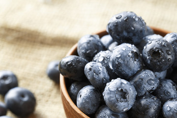 ripe organic bog whortleberry in a wooden plate