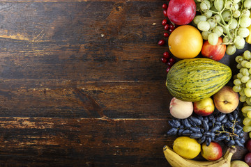 fruit background with exotic fruits on a brown wooden background, fruit detox