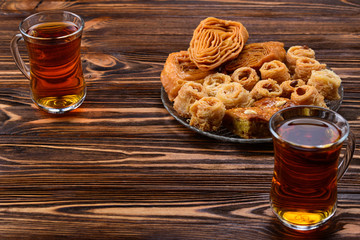 Turkish sweet baklava on plate with Turkish tea.
